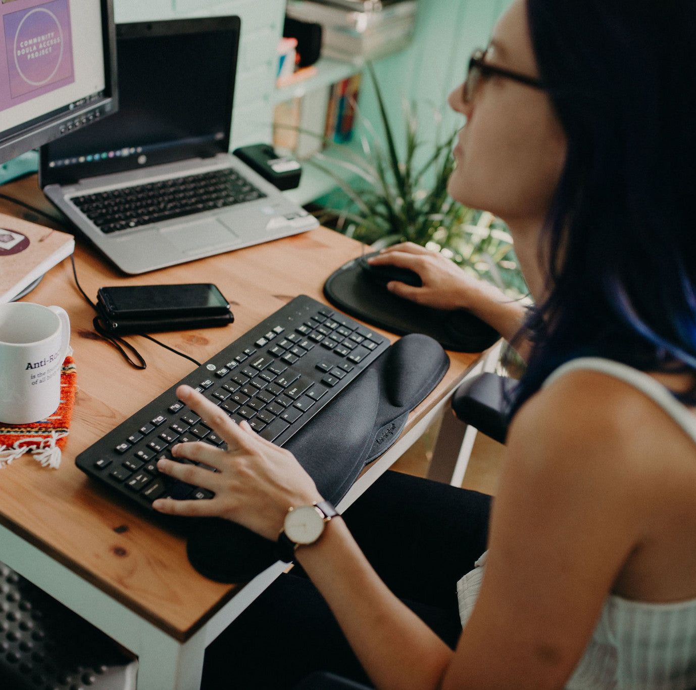 an aspiring doula works at the computer to complete their online full spectrum doula training course